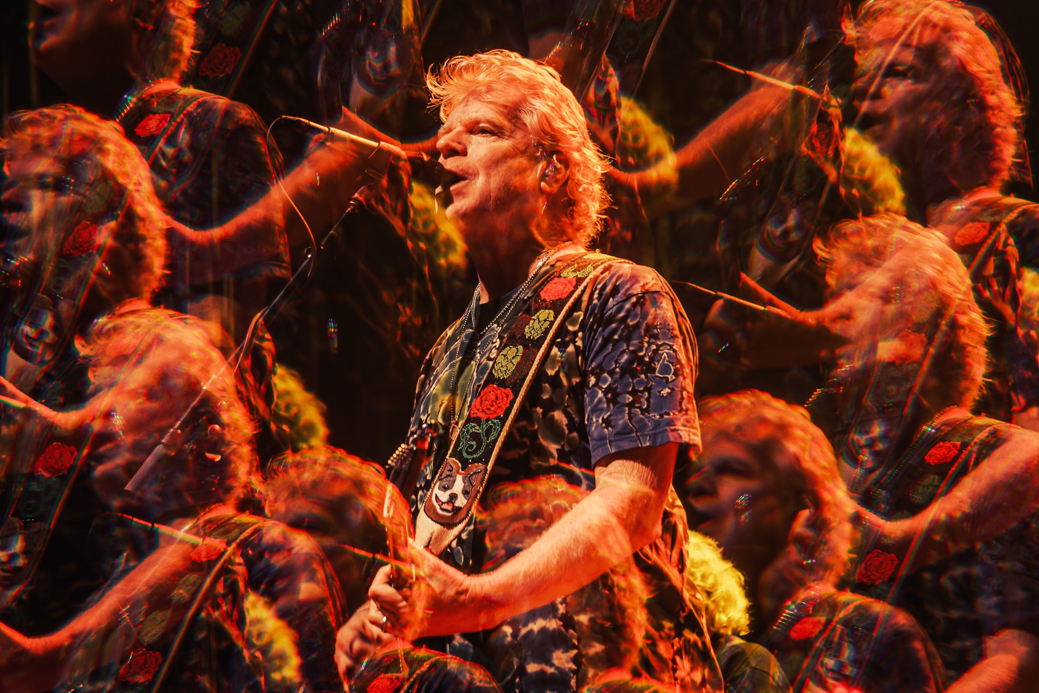 Guitarist singing with psychedelic motion blur and warm orange lighting