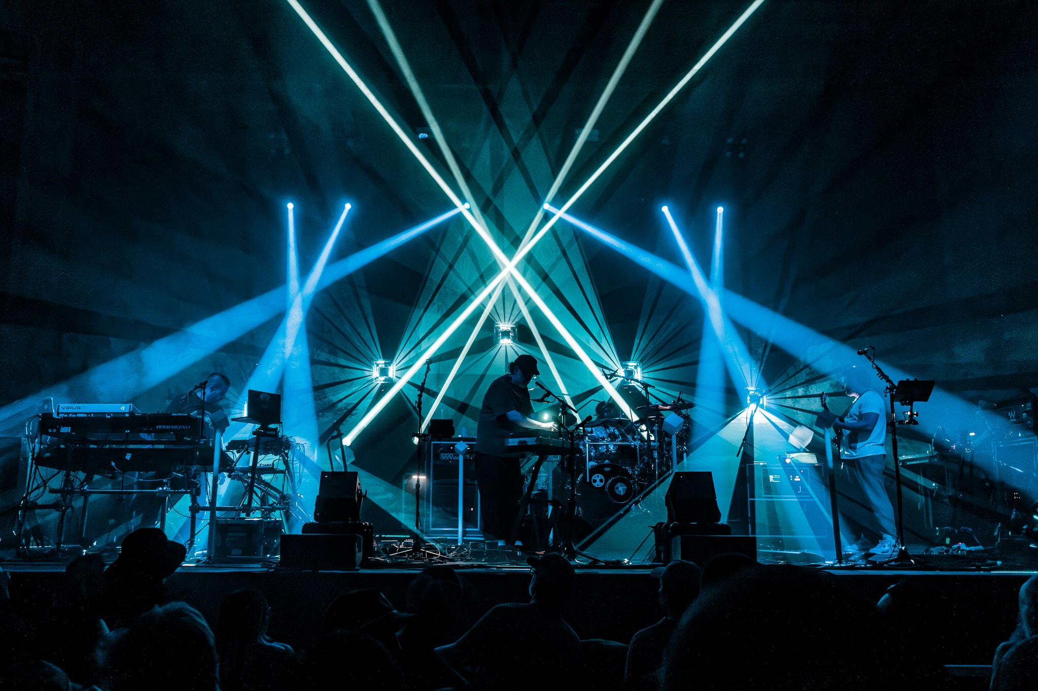 Band performing with geometric neon light show