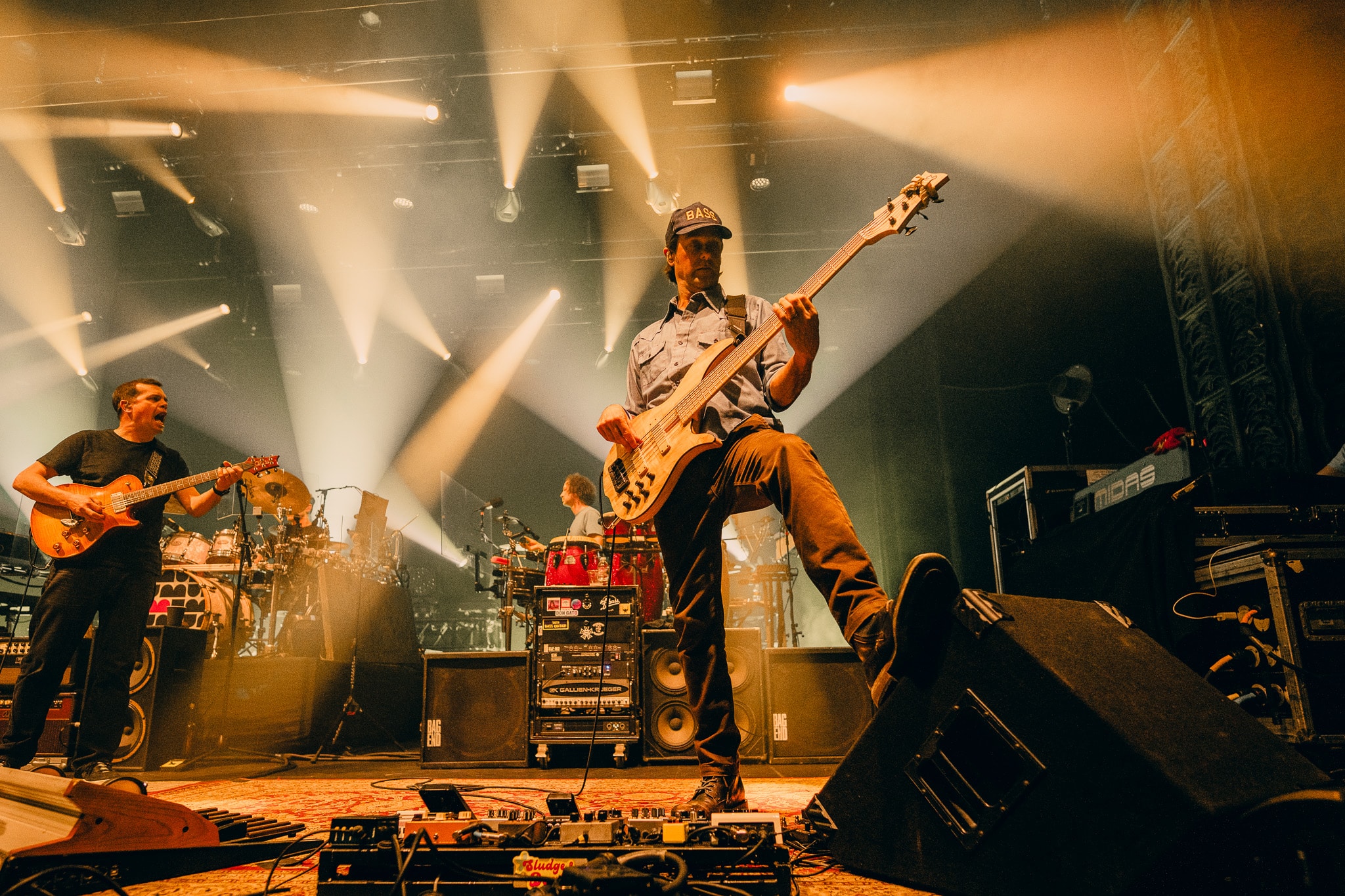 Bassist performing on stage with warm golden stage lighting